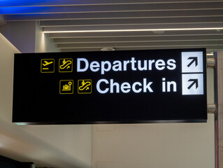 Departures and check in sign at Manchester Airport