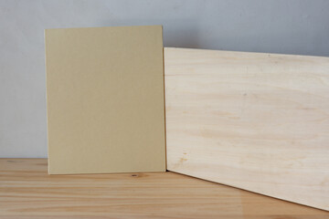 plywood and textured paper on a wooden surface (with canvas background)