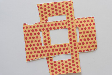 two interlocked paper frames with dots