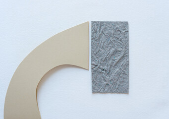 two paper shapes on light background
