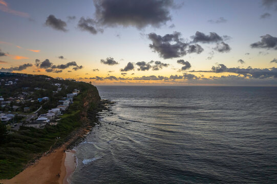 Breezy aerial sunrise seascape with clouds