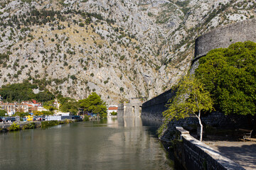   Kotor old wall Fortification in Montenegro. Unesco world heritage. Europe travel site. Vacation concept.  Tourism in adriatic sea. Serbian history of balkans, fort and port buildings..