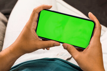Girl holding a smartphone with green screen. Chroma Key