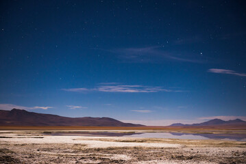 Fototapeta na wymiar Stars over Chalviri Salt Flats at night (aka Salar de Chalviri), Altiplano of Bolivia in Eduardo Avaroa National Reserve of Andean Fauna, South America