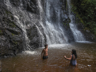 Children at the waterfall in the park