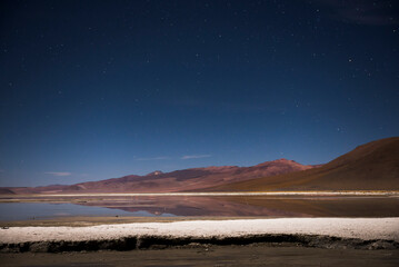Fototapeta na wymiar Stars over Chalviri Salt Flats at night (aka Salar de Chalviri), Altiplano of Bolivia, South America