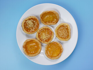 Pineapple and cheese flavored pie on blue background