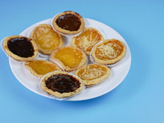 Pie flavored with chocolate, pineapple, and cheese on blue background