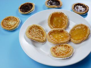 Pie flavored with chocolate, pineapple, and cheese on blue background