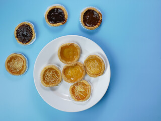 Pie flavored with chocolate, pineapple, and cheese on blue background