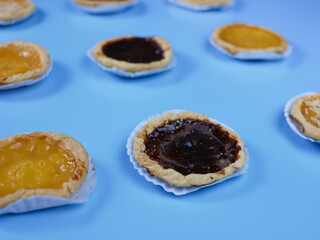 Pie flavored with chocolate, pineapple, and cheese on blue background