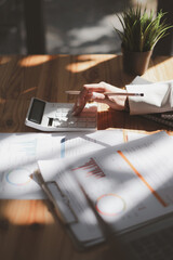 Close up Business woman using calculator for audit finance budget on wooden desk in office, tax,...