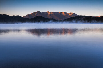 Misty sunrise at Nahuel Huapi Lake, Villa la Angostura, Neuquen, Patagonia, Argentina, background with copy space, South America, background with copy space