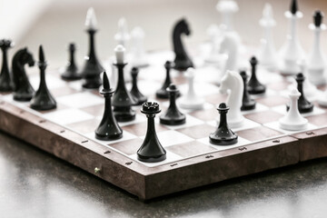 Chess pieces with game board on table, closeup