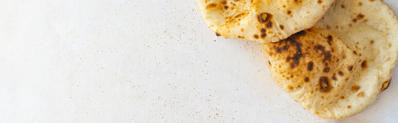 Egyptian Arab flatbreads - Aish Baladi top view on a beige background with copy space 