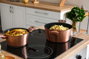 Cookware with prepared food on stove in kitchen