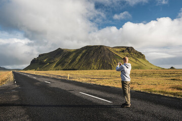 Tourist taking a photo from route 1 near Vik, South Region (Sudurland), Europe