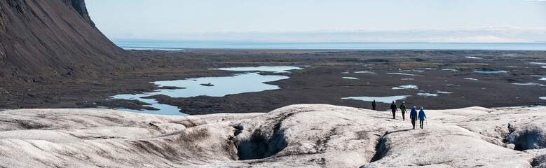 Tourists on vacation in Iceland, walking on Breidamerkurjokull Glacier, Vatnajokull Ice Cap, Europe