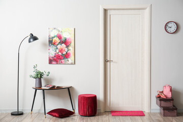 Interior of stylish hall with lamp, table and red pouf