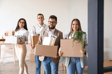 Business people holding boxes with things in office on moving day