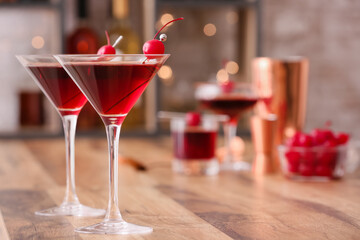 Glasses of tasty Manhattan cocktail on wooden table