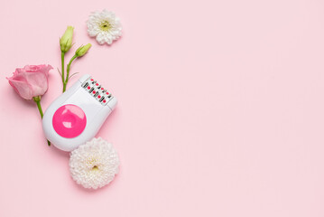 Modern epilator and beautiful flowers on pink background