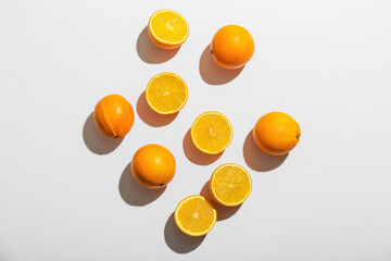 Fresh ripe cut oranges on white background