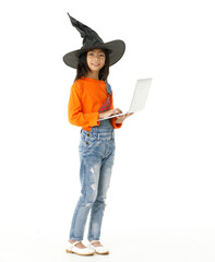 Cutout isolated studio shot of Asian young cute girl in casual orange party costume with black witch hat standing holding hand up say hi greeting on video call via laptop computer on white background