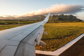 View of airplane wing at sunset, Madagascar, Africa - obrazy, fototapety, plakaty