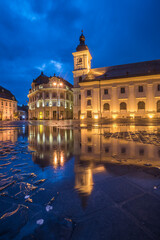 Piata Mare (Great Square) at night, with Sibiu City Hall on left and Sibiu Baroque Jesuit Church on right, Transylvania, Romania