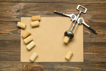Blank paper sheet, opener and corks on wooden background