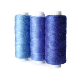 Blue sewing threads on white background