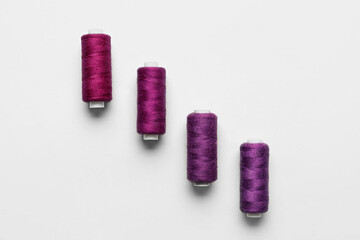 Purple sewing threads on white background