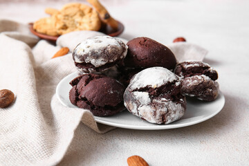 Plate of chocolate brownie cookies on light background