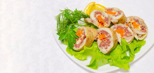 Sliced pieces of meatloaf lie on green lettuce leaves. Delicious and healthy food.