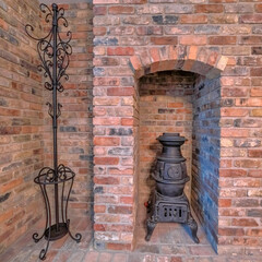 Square Fireplace with ancient cast iron stove and display stand with hooks