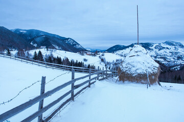 Hay stack winter landscape in the Carpathian Mountains near Bran, Transylvania, Romania