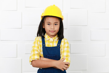 Portrait studio shot Asian young little preschooler girl future dream job career as engineering and architecture wears yellow safety hardhat helmet standing showing thumb up on white wall background