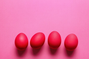 Red painted Easter eggs on color background