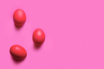 Red painted Easter eggs on color background