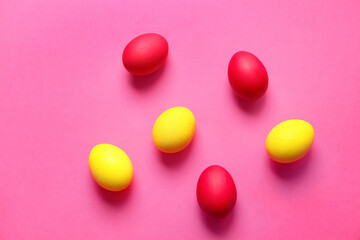 Fototapeta na wymiar Red and yellow Easter eggs on color background