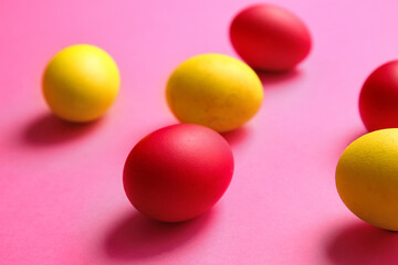Red and yellow Easter eggs on color background