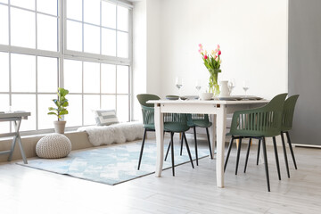 Interior of stylish room with table served for International Women's Day celebration
