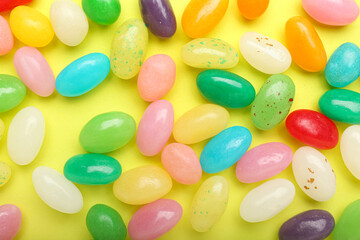 Multicolored jelly beans on color background