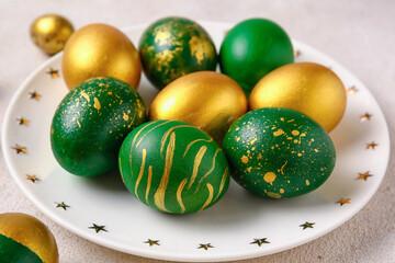 Plate with stylish Easter eggs  on light background