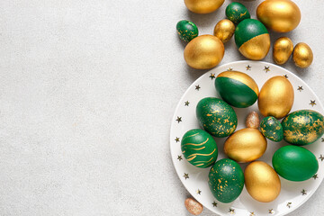 Plate with stylish Easter eggs  on light background