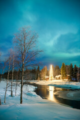 Northern Lights (aurora borealis) over Akaslompolo, a small town in Finnish Lapland, inside Arctic Circle in Finland