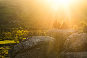 Couple on a Tor at sunset, Dartmoor National Park, Devon, England, United Kingdom, Europe