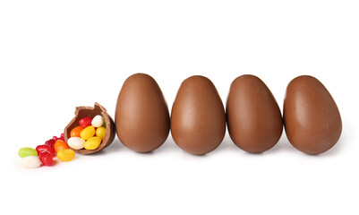 Delicious chocolate Easter eggs and different candies on white background