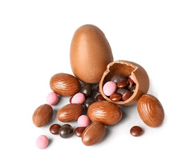 Different chocolate Easter eggs and delicious candies on light background